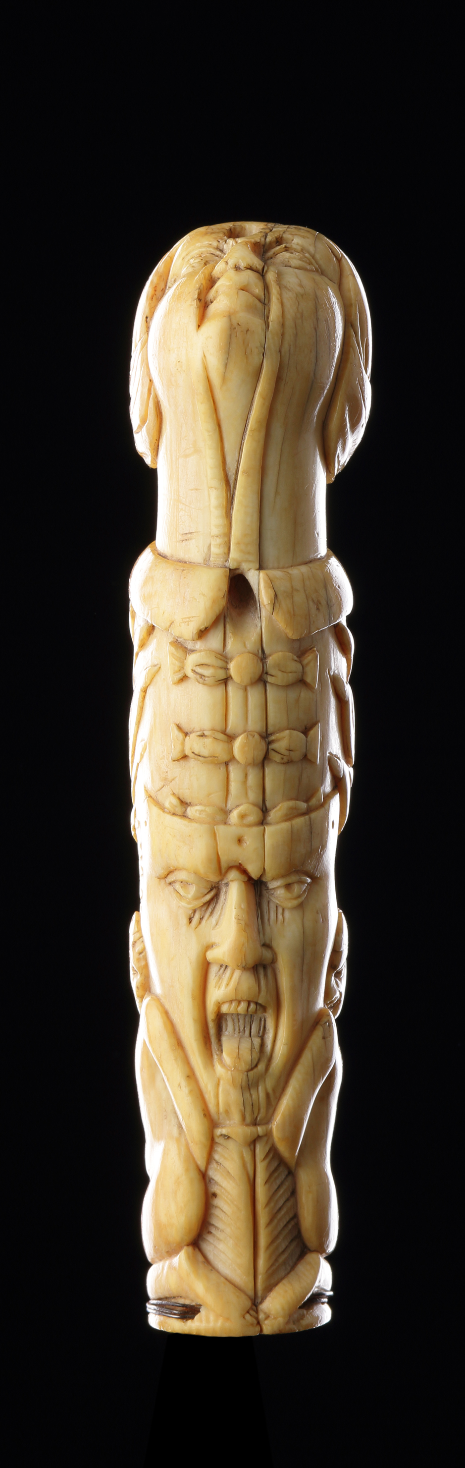 A Finely Carved Sword or Dagger Handle with a Female Head Two Grimacing Faces Flanked by Two Kneeling Naked Figures